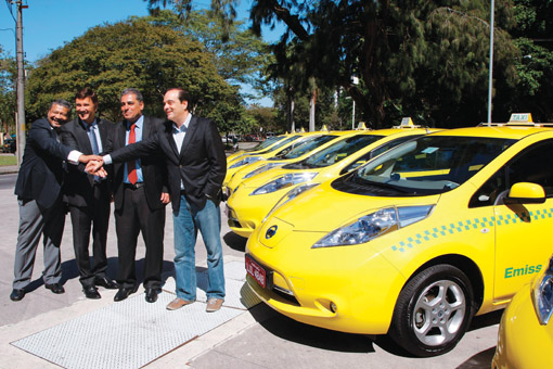 Smart cars: Brazilian Transportation Secretary Carlos Osório (far right) presents Rio's new electric taxis in September 2013. Photo: Marcos Tristao/Globo/Getty