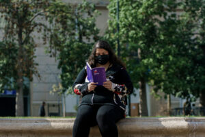 A woman reads a copy of the proposed Chilean constitution, as an up-or-down referendum on September 4 approaches.