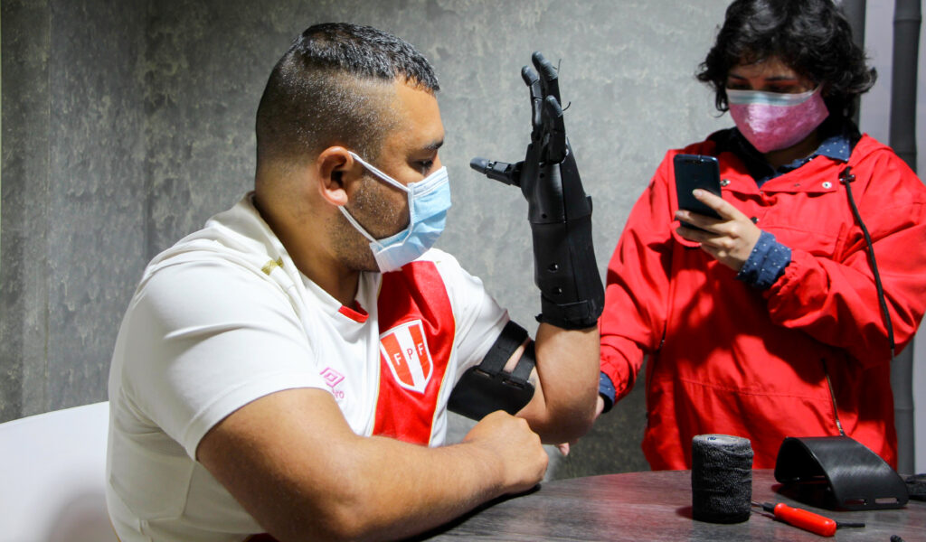 A man wears a prosthetic arm and hand developed by LAT Bionics, a Peruvian company focused on low-cost prosthetic designs.