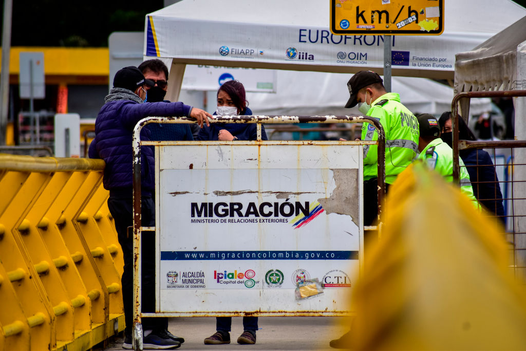 A sign written "migracion" at Colombia's border with Ecuador.