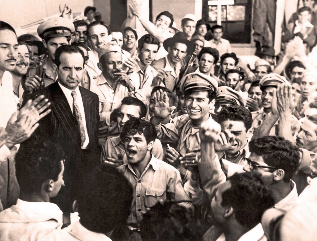 José Figueres Ferrer is surrounded by joyful supporters at the site of Figueres' declaration to abolish the army.