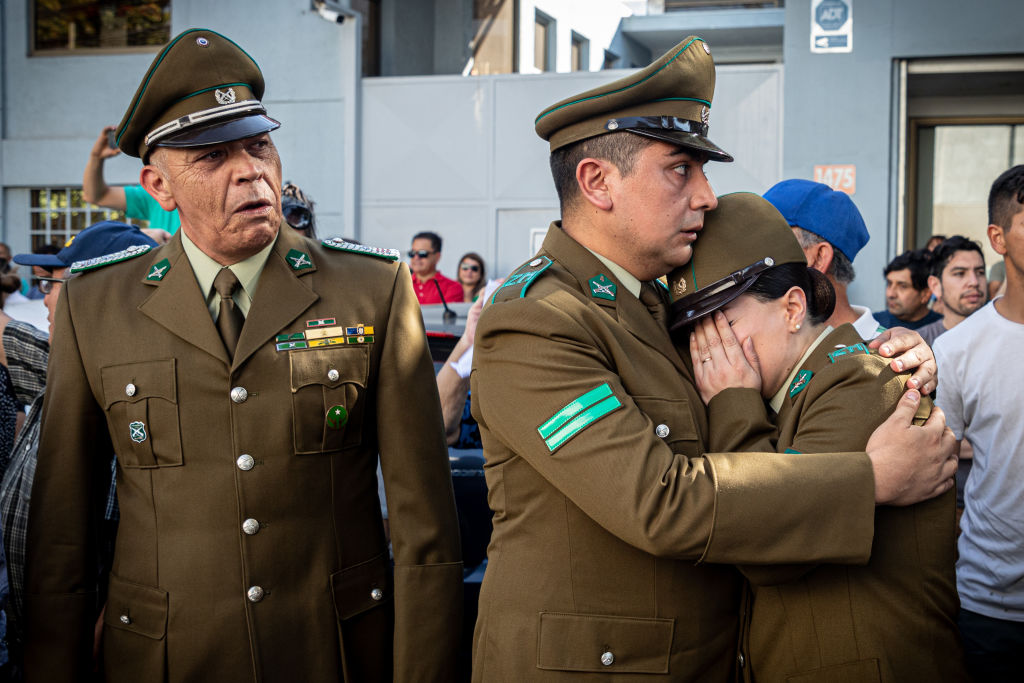 Chilean police officers grieve the murder of officer Daniel Palma, one of several police officers killed in recent months as crime rates have risen.