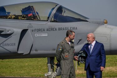 Brazilian President Luiz Inacio Lula da Silva (R) and Air Force Lieutenant Colonel Gustavo de Oliveira Pascotto pose next to the Saab's Gripen F-39 fighter jet at the Embraer factory in Gaviao Peixoto, some 310 km from Sao Paulo, Brazil, on May 9, 2023. At the Embraer factory, 15 of the 36 Gripen F-39 fighter jet units will be produced by Brazilian engineers and technicians who underwent theoretical and practical training at the headquarters of the Swedish company Saab in Linkoping. The forecast is that in 2027 the last Gripen F-39 fighter jet will be delivered. (Photo by NELSON ALMEIDA / AFP) (Photo by NELSON ALMEIDA/AFP via Getty Images)