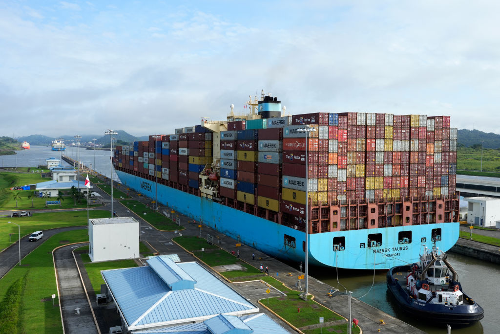 A cargo ship and tugboat sail through the Cocoli Locks at the Panama Canal in Aug. 2024. How U.S. Tariffs Are Rewiring Latin American Trade