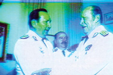 In this still from Under the Flags, the Sun, Paraguayan dictator Alfredo Stroessner (right) speaks with Andrés Rodríguez Pedotti, who later overthrew Stroessner in a coup in 1989.