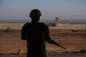 A member of the army stands outside El Salvador's CECOT maximum security prison in April.