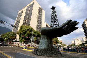 A sculpture of a hand holding an oil drilling rig outside the state-run Petroleos de Venezuela S.A. in Caracas in February 2025.