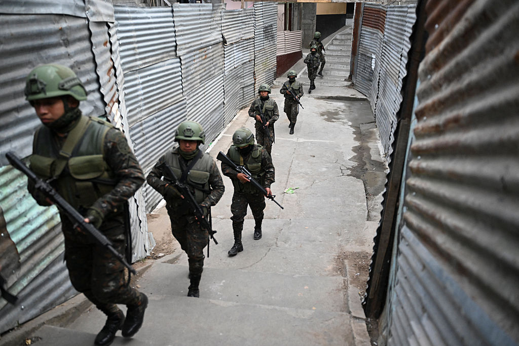 Guatemalan Army soldiers patrol a street of the Nueva Jerusalen neighborhood during the state of emergency declared by the government in Guatemala City on January 20, 2026. Guatemalan soldiers began patrolling gang-controlled neighborhoods in the capital on January 20, after attacks that left ten police officers dead and prompted the government to declare a state of siege, according to official sources and an AFP journalist. (Photo by JOHAN ORDONEZ / AFP via Getty Images)