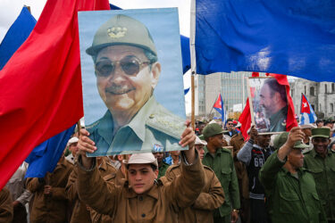 Cuban soldiers hold images of Raúl and Fidel Castro at a protest outside the U.S. Embassy in Havana in Jan.