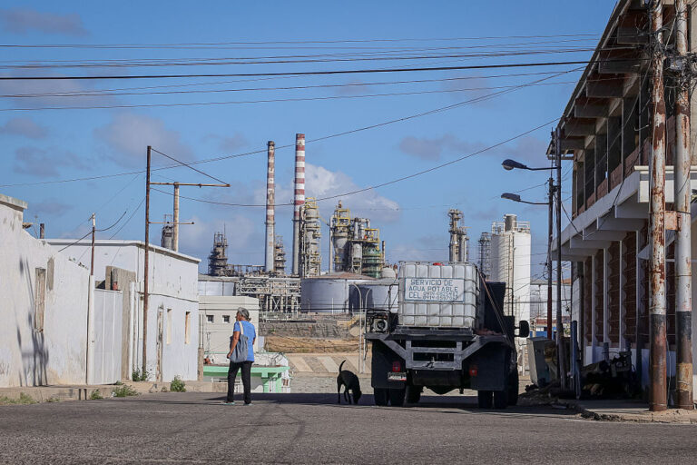 A woman walks near the Punta Cardón oil refinery in Falcón state, Venezuela, in January.
