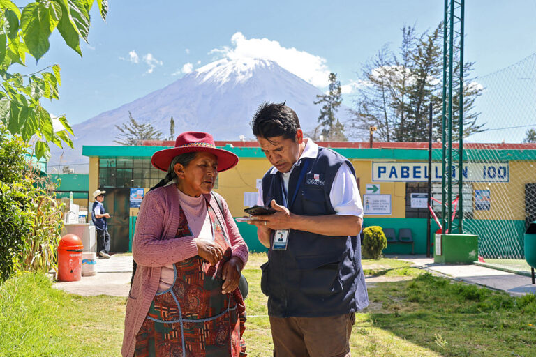 An election worker assists a voter in Chiguata, Peru, on April 12.