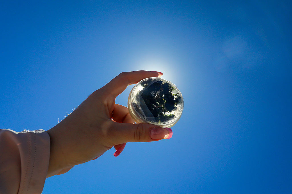 A scientist holds a sample in Peru's Ica Desert in June ahead of an astrobiology experiment testing how living organisms react 30 km from the Earth's surface.