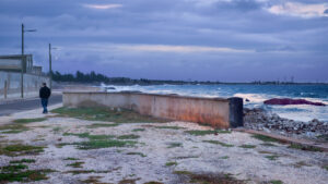 The director of The Land of the Whale, Armando Capó, walks along the shore of Gibara, Cuba.