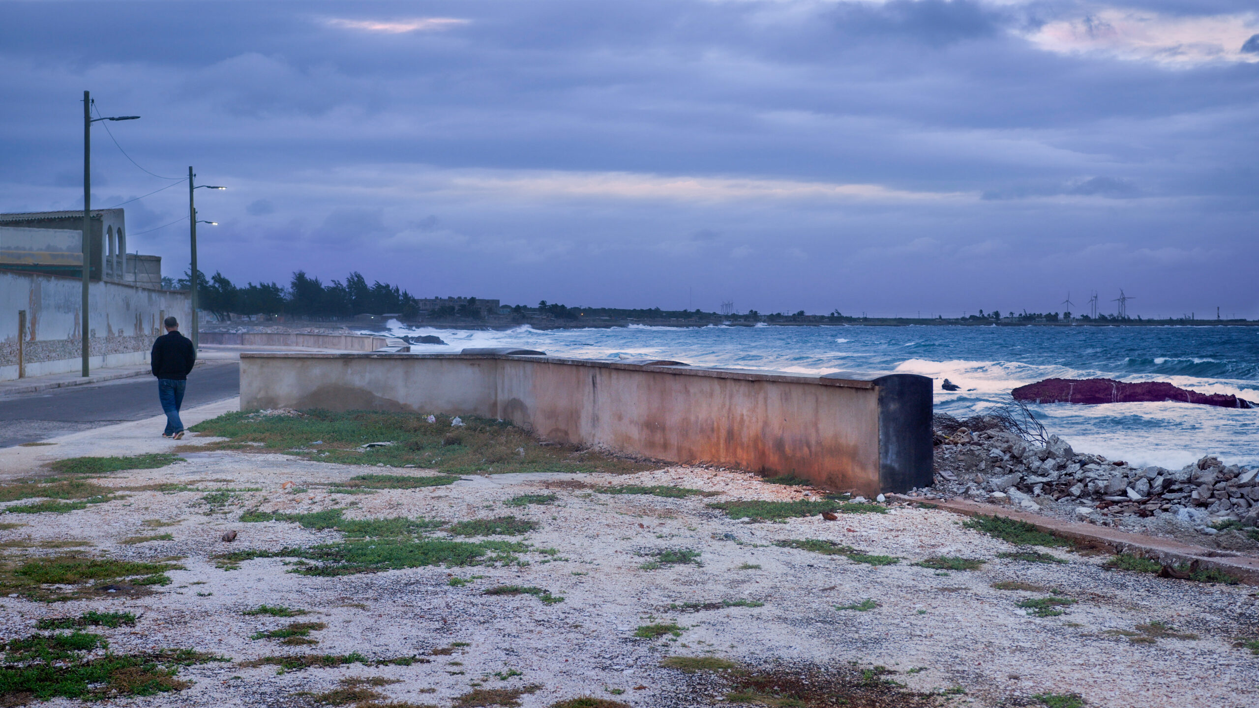 The director of The Land of the Whale, Armando Capó, walks along the shore of Gibara, Cuba.