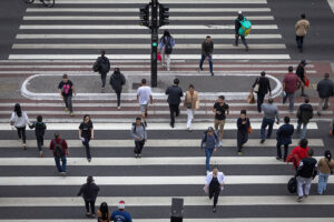 Commuters cross Avenida Paulista in the financial district of São Paulo, Brazil, in May.