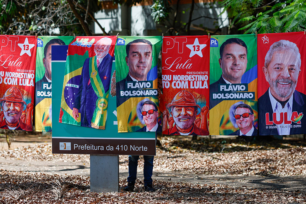 Towels and caps for sale depicting Brazilian presidential candidates Luiz Inacio Lula da Silva and Flavio Bolsonaro are seen in a residential area of Brasília on September 11, 2026. Brazil will hold a presidential elections on October 4, 2026. (Photo by Sergio Lima / AFP via Getty Images)